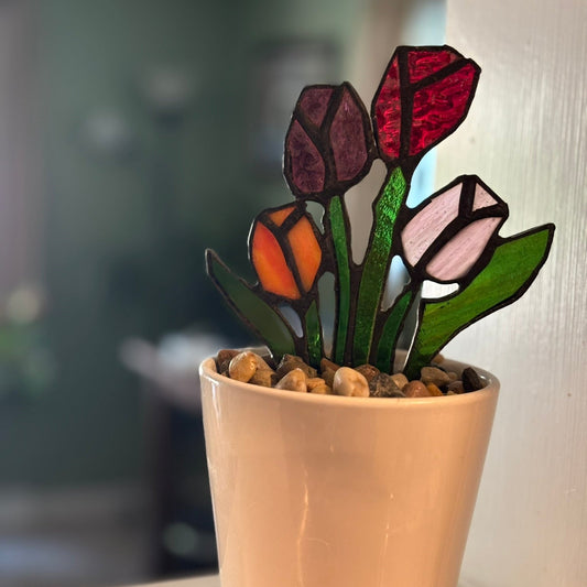 Stained glass tulips in a pot with a blurred background